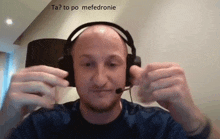 a man wearing headphones and a microphone says ta to po mefedronie