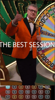 a man in an orange suit is giving a thumbs up in front of a roulette wheel