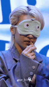 a man with a mask on his face is eating something
