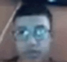 a blurry picture of a person 's face with glasses .