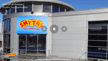 a smith 's toys superstores building with a blue sign on the front