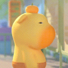 a yellow teddy bear with a pumpkin on its head is standing on a sidewalk .