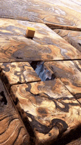 a cube is sitting on top of a wooden surface with a swirl pattern