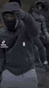 a man in a hooded jacket with the word her written on it