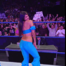 a woman in a blue outfit is holding a sign that says vanslyne