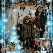 a family posing for a picture with two wolves behind them