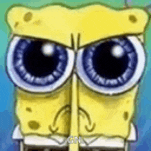 a close up of spongebob squarepants ' face with big blue eyes and a sad look on his face .