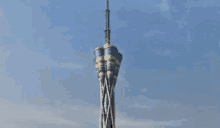 a tall tower against a blue sky with clouds .