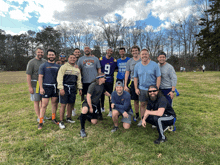 a group of men posing for a picture with one man wearing a shirt that says please do not hit me ou