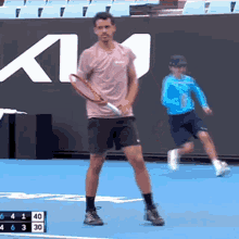 a man is holding a tennis racquet on a tennis court with a scoreboard behind him that says 6 4 40 30