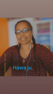 a woman wearing glasses and ear buds with hawa ju written on the bottom right