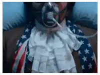 a man wearing an american flag tie and an oxygen mask on his face