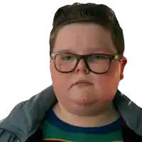 a boy wearing glasses and a striped sweater looks at the camera