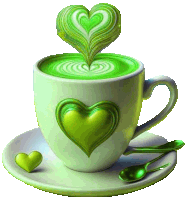 a cup of green coffee with a heart shaped foam on top