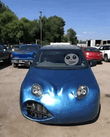 a blue car with a panda head on the windshield