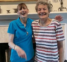 two women are posing for a picture and one of them is wearing a blue shirt