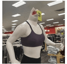 a mannequin with a shark 's head is in a clothing store