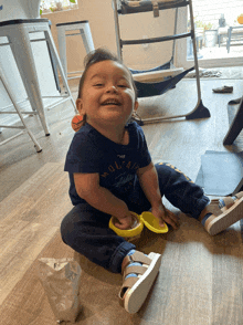 a baby wearing a blue shirt that says the mountain is smiling