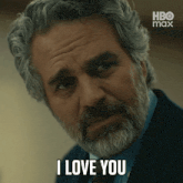 a man with gray hair and a beard is saying i love you