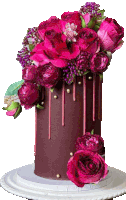 a chocolate cake with pink roses and purple berries