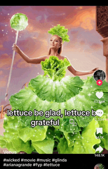 a woman in a dress made of lettuce is holding a stick