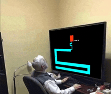 an elderly man is playing a video game on a flat screen television