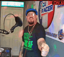 a man wearing glasses and a shirt that says ' dj racer ' on it