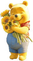 winnie the pooh is holding a bouquet of sunflowers and smiling