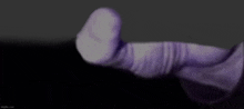 a close up of a person 's arm with a purple glove on it .