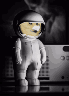 a figurine of an astronaut with a doge face on his helmet