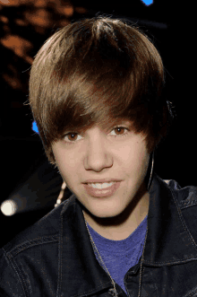 justin bieber wearing a blue shirt and a black jacket