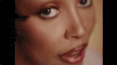 a close up of a woman 's face with a very long eyelash .