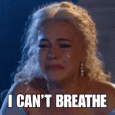 a woman is crying with the words `` i can 't breathe '' on her face .