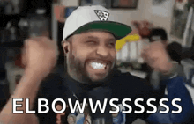 a man wearing a hat and ear buds is making a funny face while holding his fist in the air .