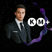 a man in a suit and tie is standing in front of a km + logo