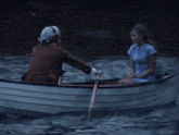 a man rowing a boat with a woman sitting in the boat