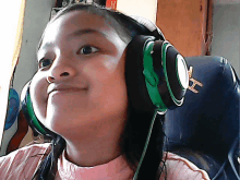 a young girl wearing headphones with a letter h on it