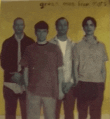 a group of young men standing in front of a yellow background with the words green men from mars