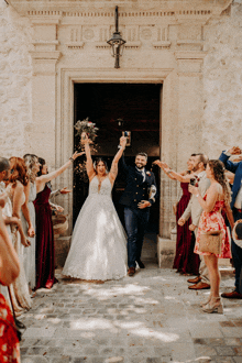 a bride and groom are being congratulated by their wedding party