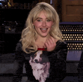 a woman wearing a black dress with a picture of a dog on the front