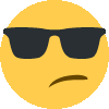 a yellow smiley face wearing black sunglasses and making a funny face .