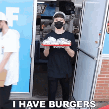 a man wearing a mask holds a tray of burgers in front of a door that says i have burgers on it