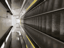 an empty escalator with a yellow stripe on the side