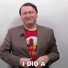 a man wearing a suit and a red shirt says " i did a "