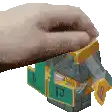 a hand is holding a block with a green and yellow block on it .