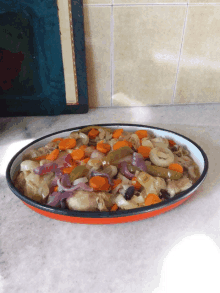 a plate of food with carrots and onions on a table