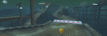 a yellow ball is on a wooden surface with a sign that says aaa on it