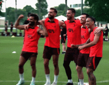 a group of soccer players are posing for a picture and one of their shirts says ' aa ' on it