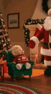 a teddy bear wearing a sweater that says snowflakes is sitting in a chair next to santa