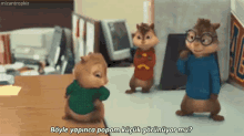 a group of alvin and the chipmunks are standing around a table and talking to each other